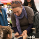 A woman and her daughter go shopping with their EBT coupons. Image via Getty.